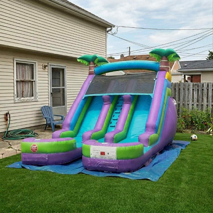 Beyond Tent 13' Lightweight Violet Twin Slide set up on green turf in a backyard, house with a blue Adirondack chair and wood privacy fence in the background