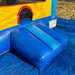Close-up of the inflatable entrance ramp and safety tunnel for the Beyond Tent 13x13 Celebration Bouncer, featuring reinforced blue PVC vinyl and set up on a protective blue ground tarp.
