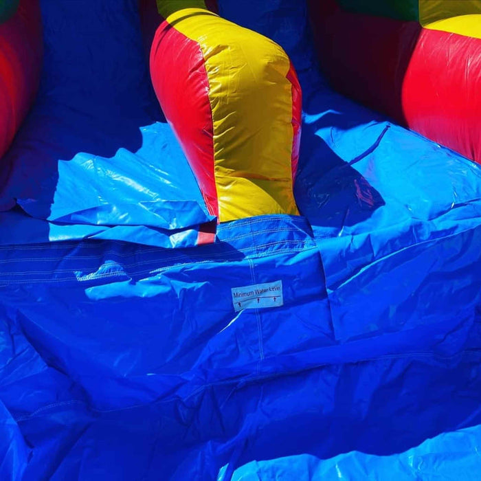 Side profile view of 18-foot Rainbow Dual Lane inflatable waterslide showing full height and dual lane design — Beyond Tent commercial rental
