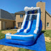 Inflatable water slide on a grassy lawn with houses in the background