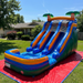 Beyond Tent 18' Double Lane Splash Wet and Dry Slide set up in a residential backyard on a red ground tarp, water flowing down the dual lanes, house and trees in background