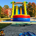 18' Tropical Adventure Double Lane inflatable slide safety features infographic: finger-safe netting, emergency exit, ASTM and CPSIA compliant, fire retardant and lead-free 15oz PVC — Beyond Tent
