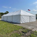 Large white tent with an American flag on a clear day