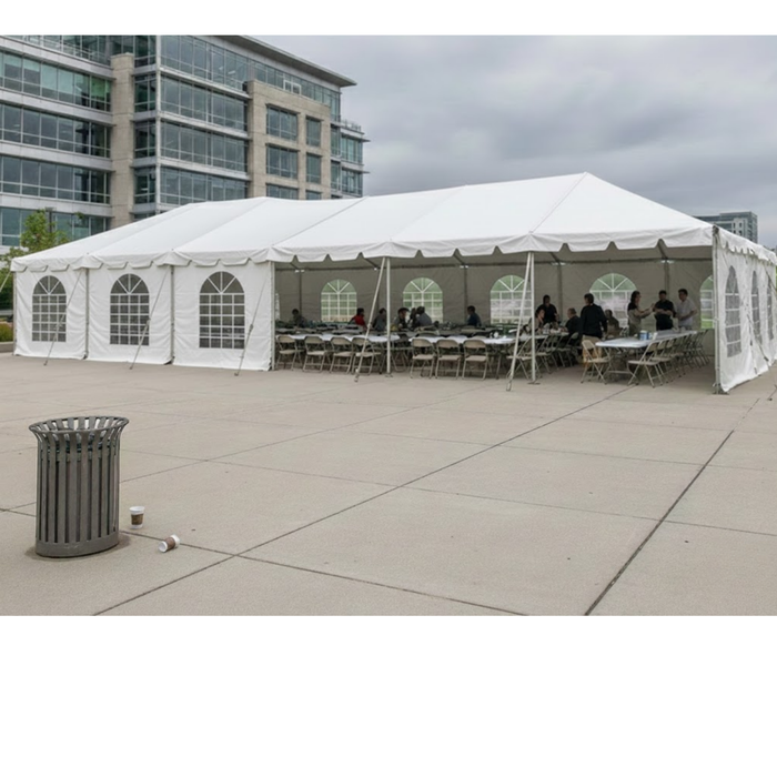 Beyond Tent 20x60 Classic Series West Coast Frame Tent setup on a concrete plaza with windowed sidewalls and banquet tables set up inside