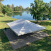 30x40 Classic Series West Coast, set up on concrete with a lake behind. Sunny day. Beyond Tent exclusive picture. 