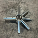 A galvanized 6 way crown for a West Coast Frame Tent and pre-drilled holes, photographed on a scratched concrete floor.