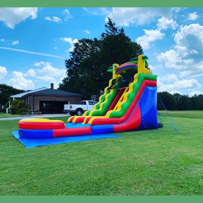 18-foot Rainbow Dual Lane waterslide splash pool landing zone and slide exit area — commercial rental unit with safety netting, Beyond Tent