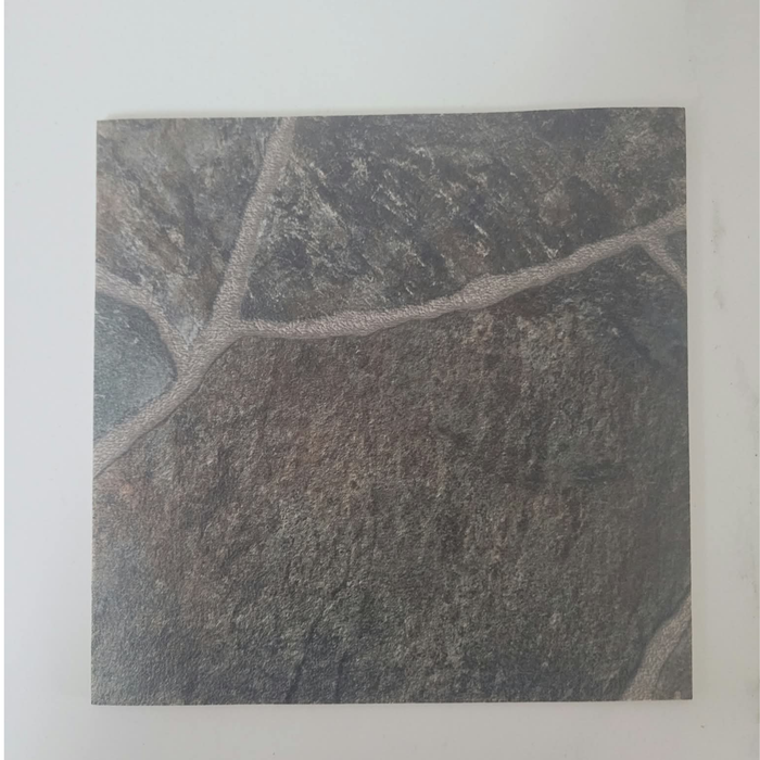 Beyond Tent Ash Stone Rolled Vinyl Flooring sample swatch shown at a close angle on a white surface, highlighting the stone-tile print pattern
