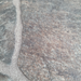 Beyond Tent Ash Stone Rolled Vinyl Flooring extreme close-up of the printed stone-tile texture and grout seam detail