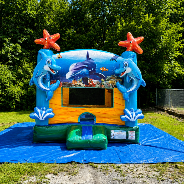 Atlantis Inflatable Castle in a backyard, sunny day. Blue tarp under it. 