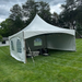 Beyond Tent 20x20 High Peak Frame Tent  White  set up on a grassy area with trees in the background with window walls 