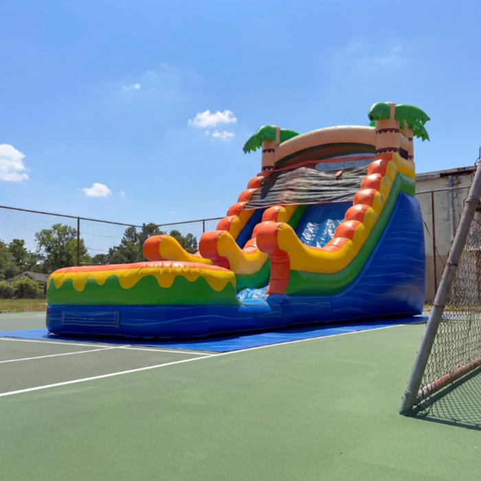 Colorful inflatable water slide on a tennis court with palm tree decorations. 16' Sunset with tarp. 
