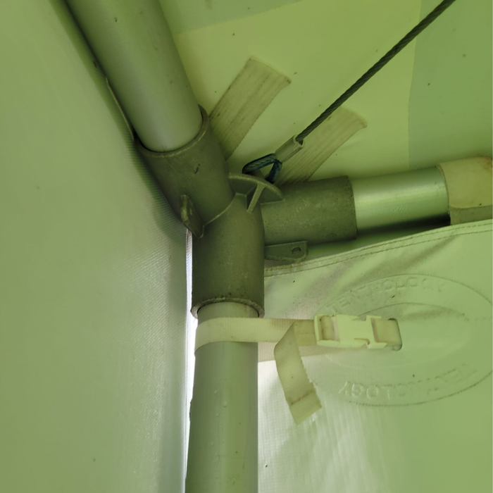 Close-up of a corner fitting  structure with pipes and clamps.