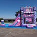 KPOP Combo Wet N Dry fully inflated and set up on an outdoor asphalt surface under a bright blue sky; full side view shows the pink, purple, and magenta bounce chamber with KPOP signage on the front panel, silver truss framing on both sides, and the curved slide with blue splash pool visible at the right side.