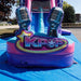 Ground-level close-up of the splash pool and curved slide base of the KPOP Combo Wet N Dry; inflatable splash landing pool in pink and purple tones visible at the foot of the curved slide; asphalt surface beneath; surrounding unit walls in pink and magenta visible in the background.