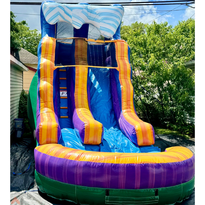 Beyond Tent 15' Lightweight Caribbean Wave Waterslide backyard setup with trees and neighboring houses in the background