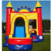 Outdoor setup of the Rainbow Play Wet & Dry Unisex Combo inflatable. View of the commercial-grade castle design in red, blue, and yellow with a front-facing water slide, safety entrance, and yellow turret towers on a grassy lawn