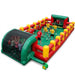 Inflatable human foosball interactive game arena with adult players holding onto aluminum safety poles inside a heavy-duty green and red vinyl structure.