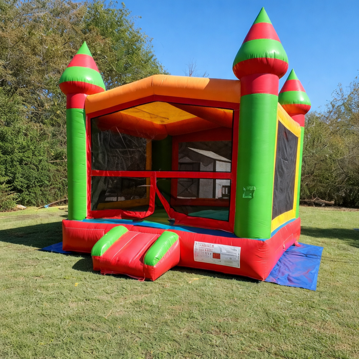 Beyond Tent Lightweight Fiesta Bouncer - Commercial Grade, colorful red green and orange castle style bounce house with striped turrets, angled view set up in grass