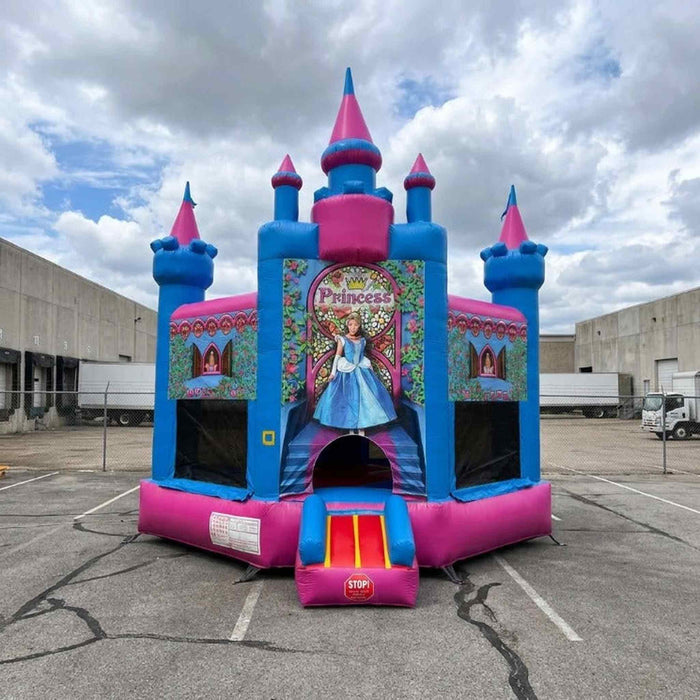 Beyond Tent Lightweight Magic Princess Castle with Blower, pink and blue castle bounce house with a Princess stained-glass mural graphic, set up in a warehouse loading dock lot