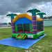 Beyond Tent Lightweight Palm Tree Bouncer set up on a blue tarp on grass under a stormy sky, with a building and palm trees in the background