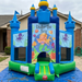 Inflatable bounce house with 'Under the Sea' design in front of a house.