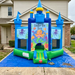 Blue inflatable bounce house with 'Under the Sea' design on a blue tarp outside a house.