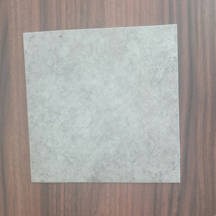 Natural Grey Vinyl Flooring | Commercial Grade
 displayed flat on a dark brown wood-grain surface.