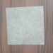 Natural Grey Vinyl Flooring | Commercial Grade
 displayed flat on a dark brown wood-grain surface.