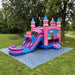 Royal Princess Bounce House Combo Wet &amp; Dry — Commercial Grade  set up on a gray ground cover in a grassy park with trees in the background.