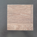 Rustic Oak vinyl flooring plank sample on a dark wood-grain surface, highlighting the brown wood-look grain pattern and seam lines