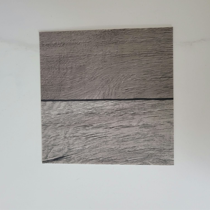 Beyond Tent Silver Oak commercial-grade vinyl flooring tile sample, alternate plank orientation showing wood-grain texture, top-down view on white background