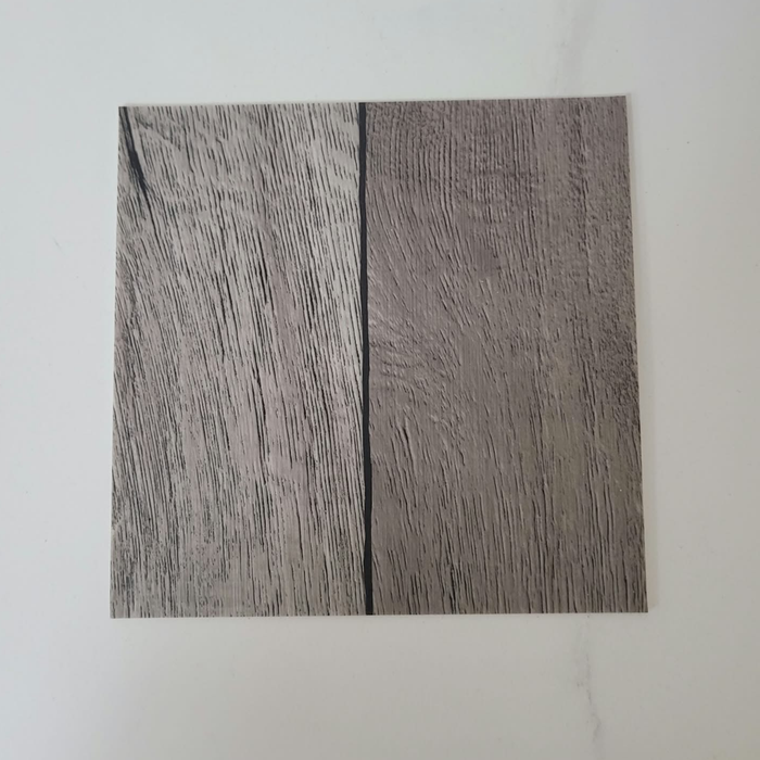 Beyond Tent Silver Oak commercial-grade vinyl flooring tile sample, wood-grain texture in muted gray tones, top-down view on white background