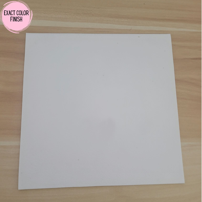 Matte White Rolled Vinyl Flooring sample swatch on a light oak wood table, pink Exact Color Finish badge in the top left corner