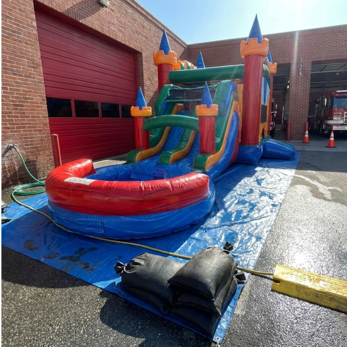 Twin Tower Dash inflatable bounce house water slide combo – studio render showing full 4-in-1 setup: dual bounce lanes, castle towers, curved slide, and splash pool for kids party rental