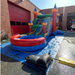 Twin Tower Dash inflatable bounce house water slide combo – studio render showing full 4-in-1 setup: dual bounce lanes, castle towers, curved slide, and splash pool for kids party rental