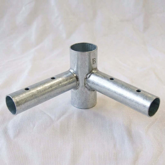 West Coast Frame Tent 2-Way Corner Rail Fitting  featuring pre-drilled holes on the side arms and a stamped letter 'B' on the vertical section, displayed on a white fabric background.