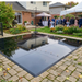 Beyond Tent 12x12 Glossy Black portable dance floor with a high-shine reflective finish and interlocking panels, professionally installed for a luxury event.