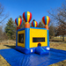 Beyond Tent 13x13 Celebration Bouncer with 18oz commercial PVC vinyl and hot air balloon corner pillars, set up on a manicured grass lawn with a professional wood fence and tree background.