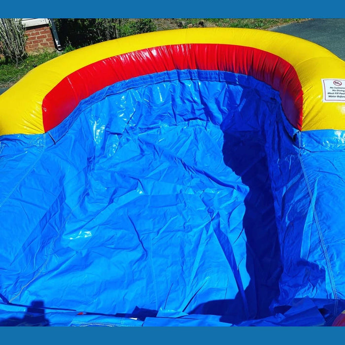 18ft Rainbow Dual Lane waterslide with soaking arch and splash pool — outdoor summer event setup, Beyond Tent commercial-grade inflatable