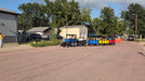Frontier Gas Powered Trackless Train in action carrying passengers down a paved street at a festival. Beyond Tent Exclusive video. Product performance. 